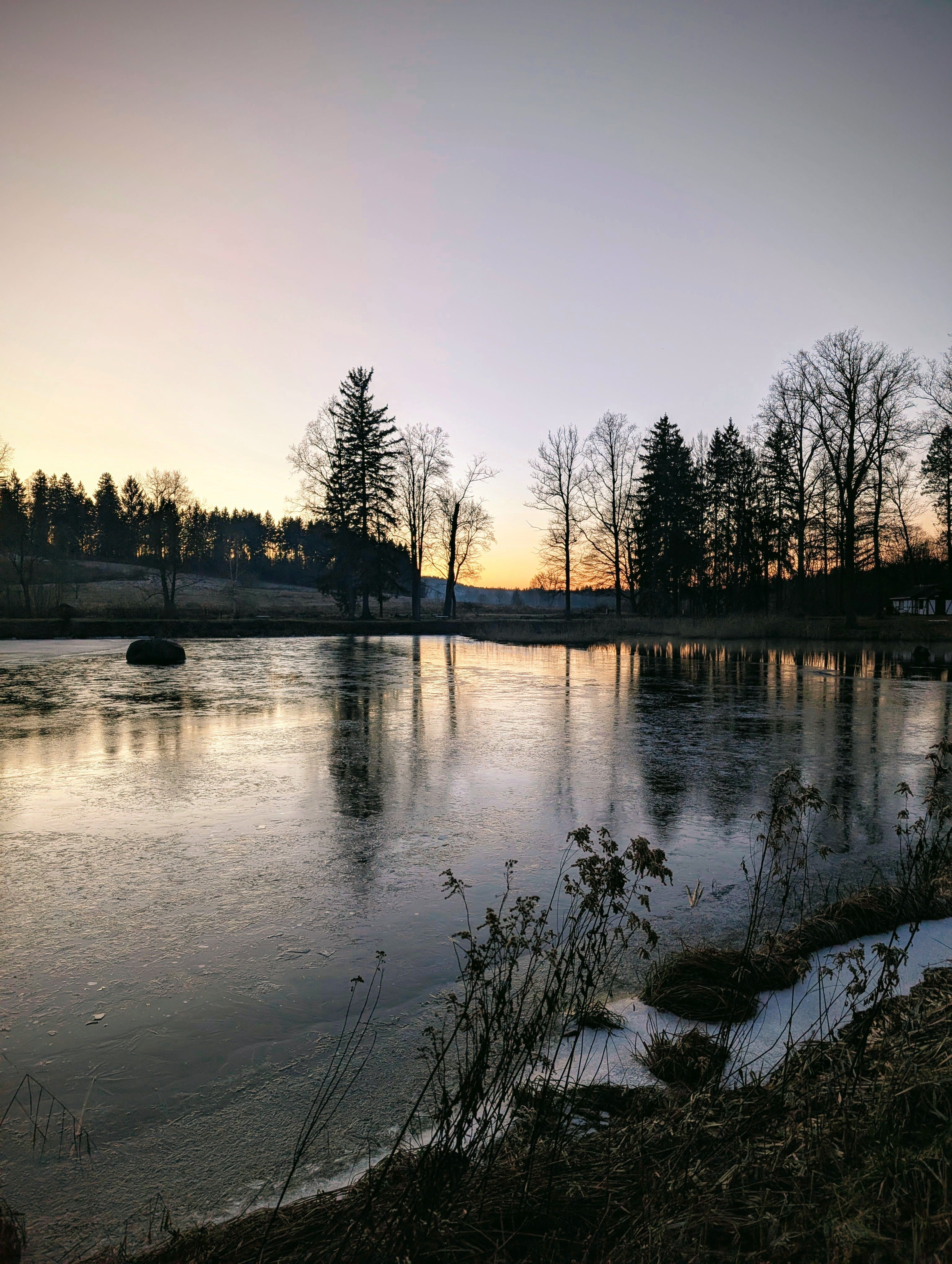 Serene Winter Sunset Over Frozen Lake · Free Stock Photo