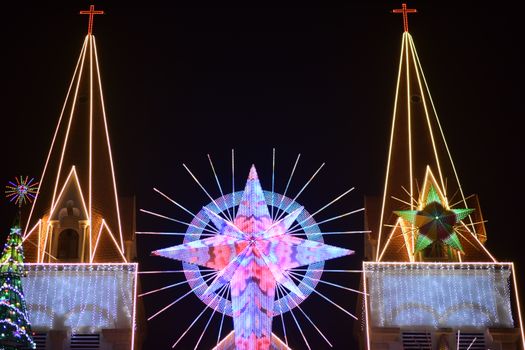 Stunning night view of a church adorned with vibrant Christmas lights and decorations, creating a festive atmosphere.