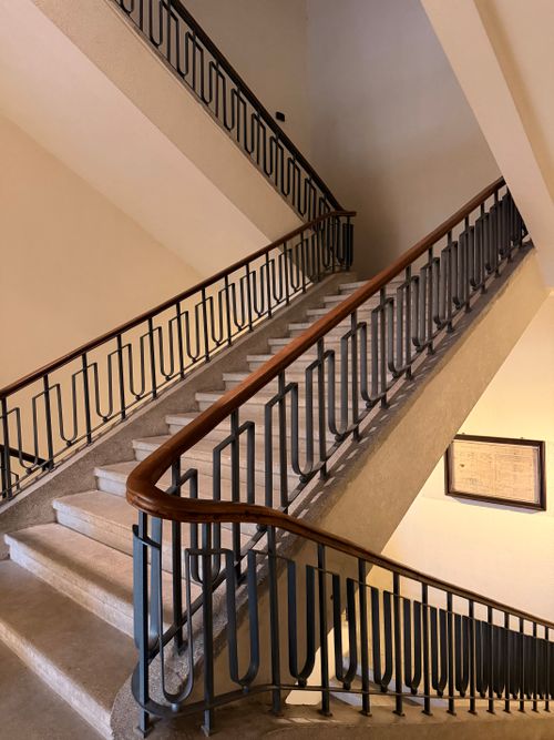 Free A stylish spiral staircase in a historic indoor setting with artistic railing. Stock Photo