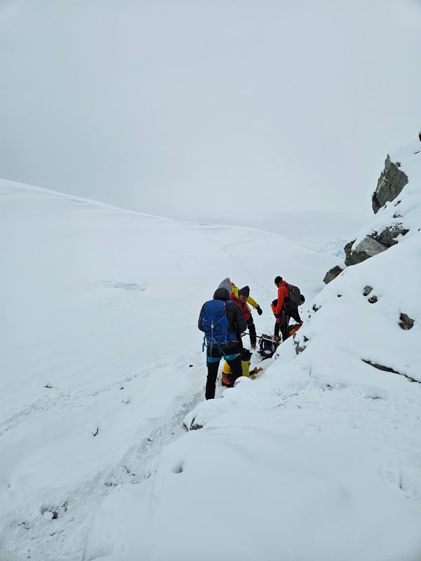 Climbers crossing a snow-covered mountain slope — photo by Kunal Prabhakar on Pexels