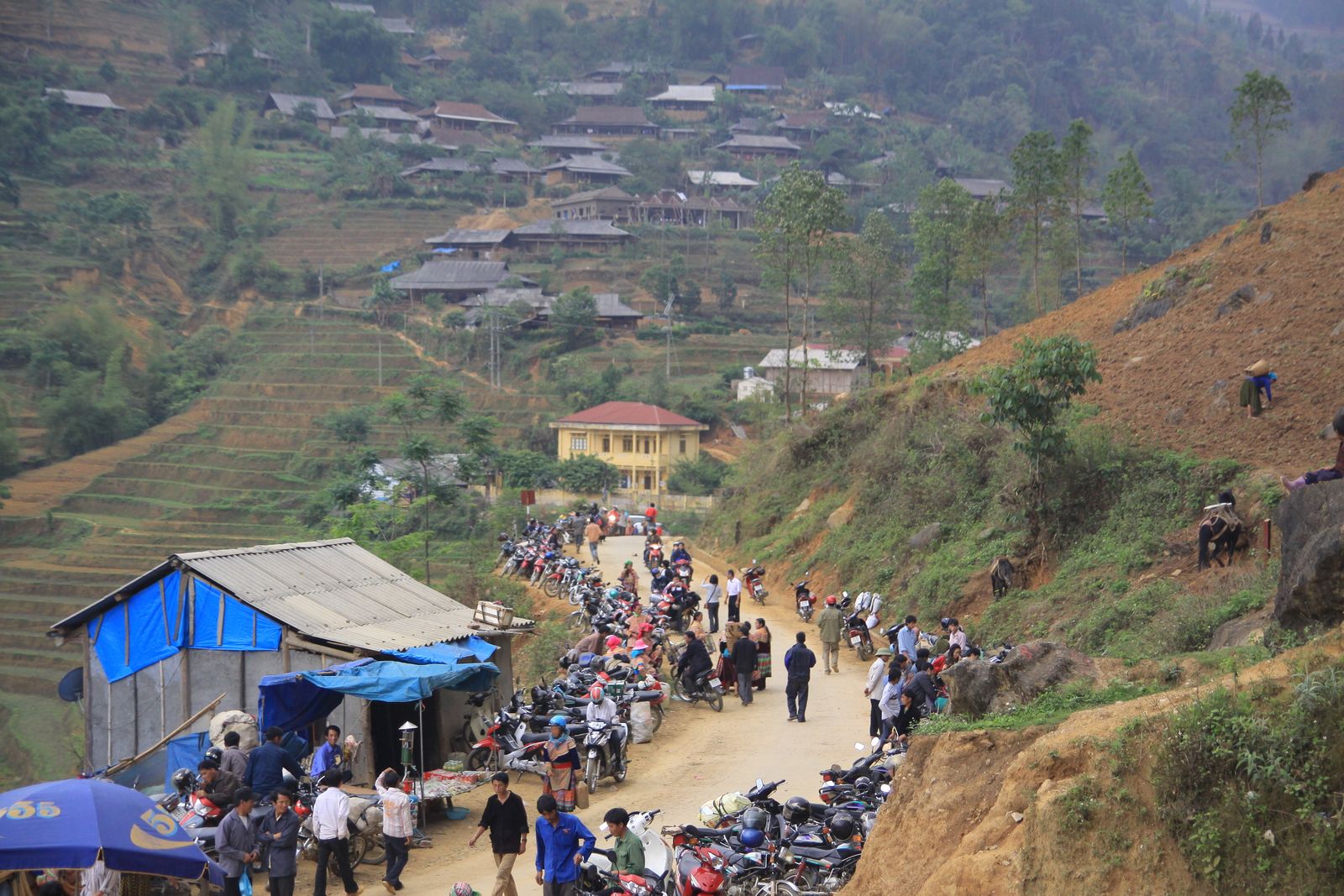 Bustling mountain village market scene in Vietnam showing local culture guests discover while traveling Ha Giang