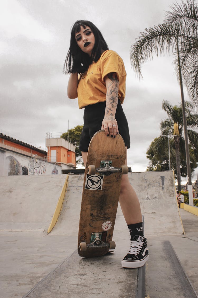 Woman Holding Skateboard