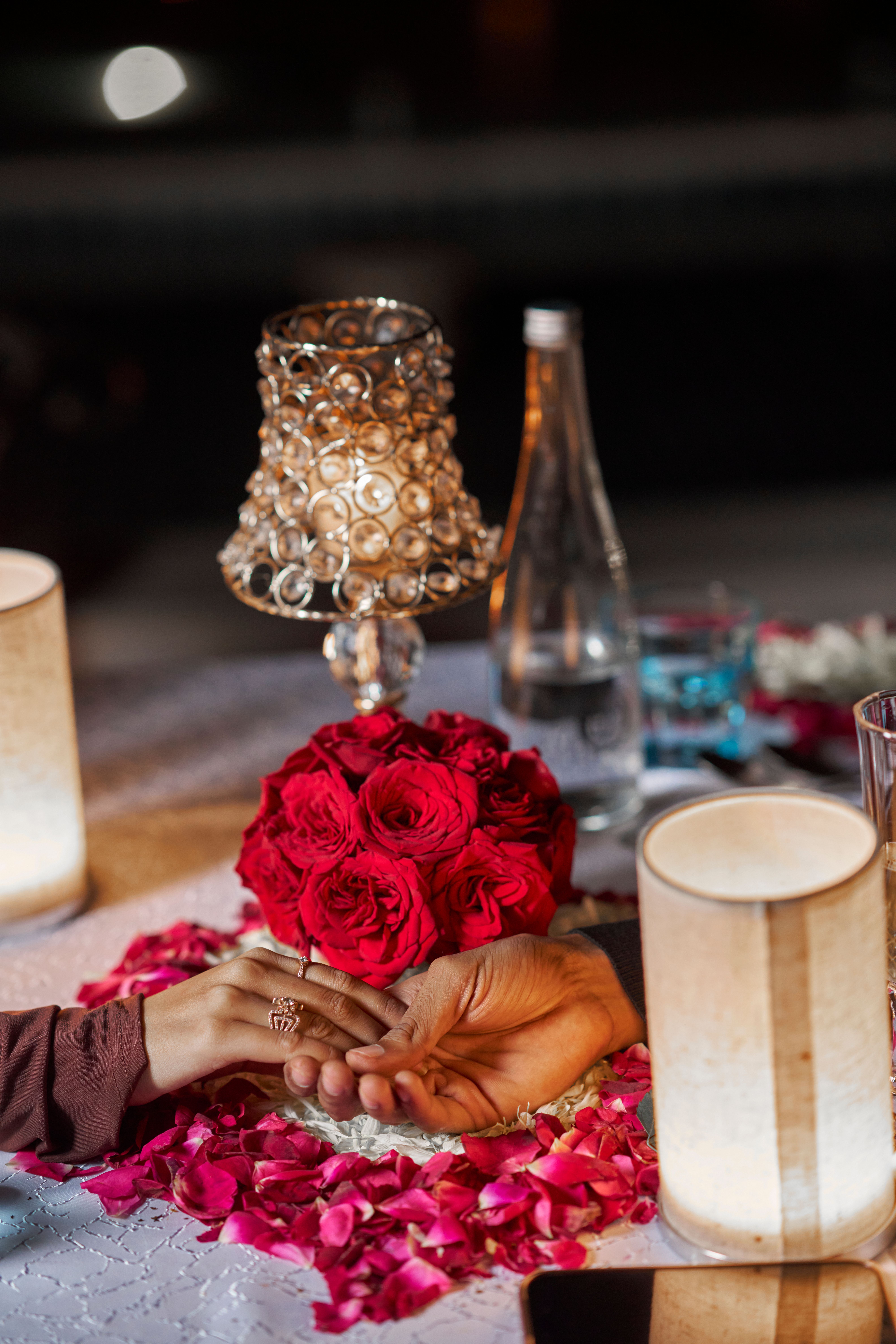 Couple holding hands at candlelight dinner