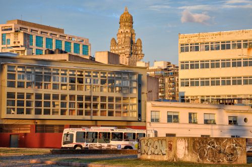 Free A view of Montevideo's urban landscape at sunset, highlighting Palacio Salvo and surrounding buildings. Stock Photo