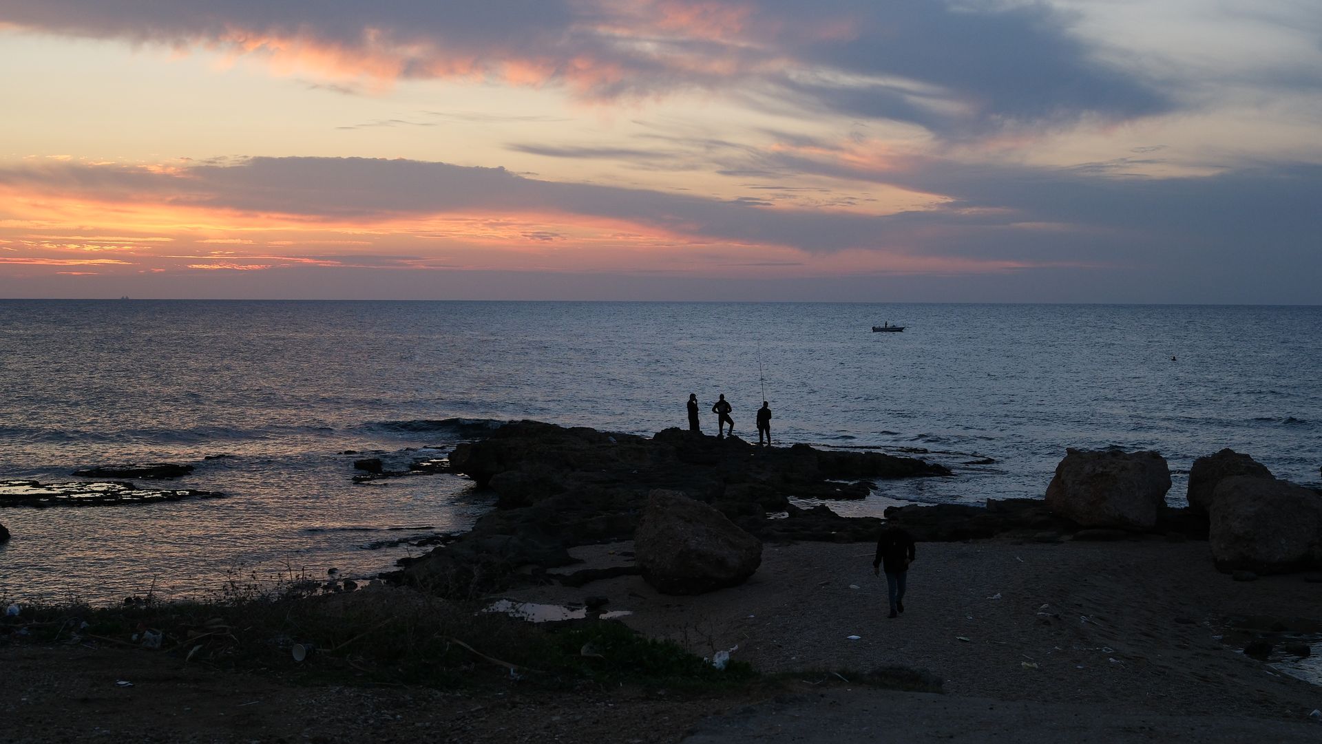 A calm Mediterranean horizon with scattered clouds