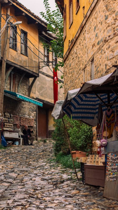 Free Quaint cobblestone street with rustic architecture in a traditional village setting. Stock Photo