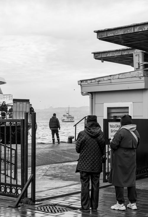 Free A monochrome view of people at a ferry dock in Istanbul, capturing daily life and urban activity. Stock Photo
