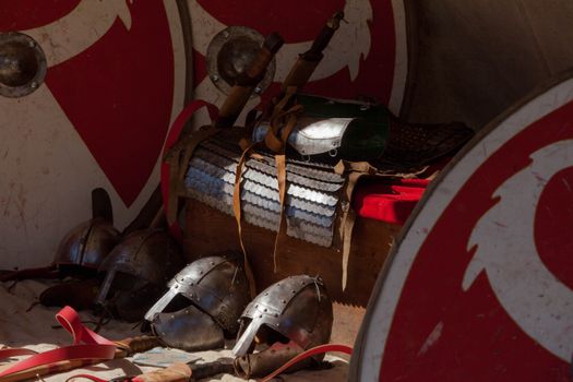 Detailed display of ancient Roman armor and weapons, showcasing historical artifacts.