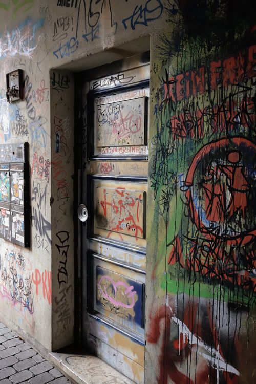Free A colorful graffiti-covered door in Göttingen, Germany, showcasing urban street art. Stock Photo