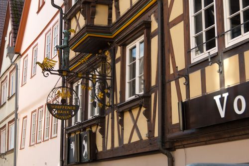 Free Charming half-timbered building with intricate signage in Germany's scenic townscape. Stock Photo