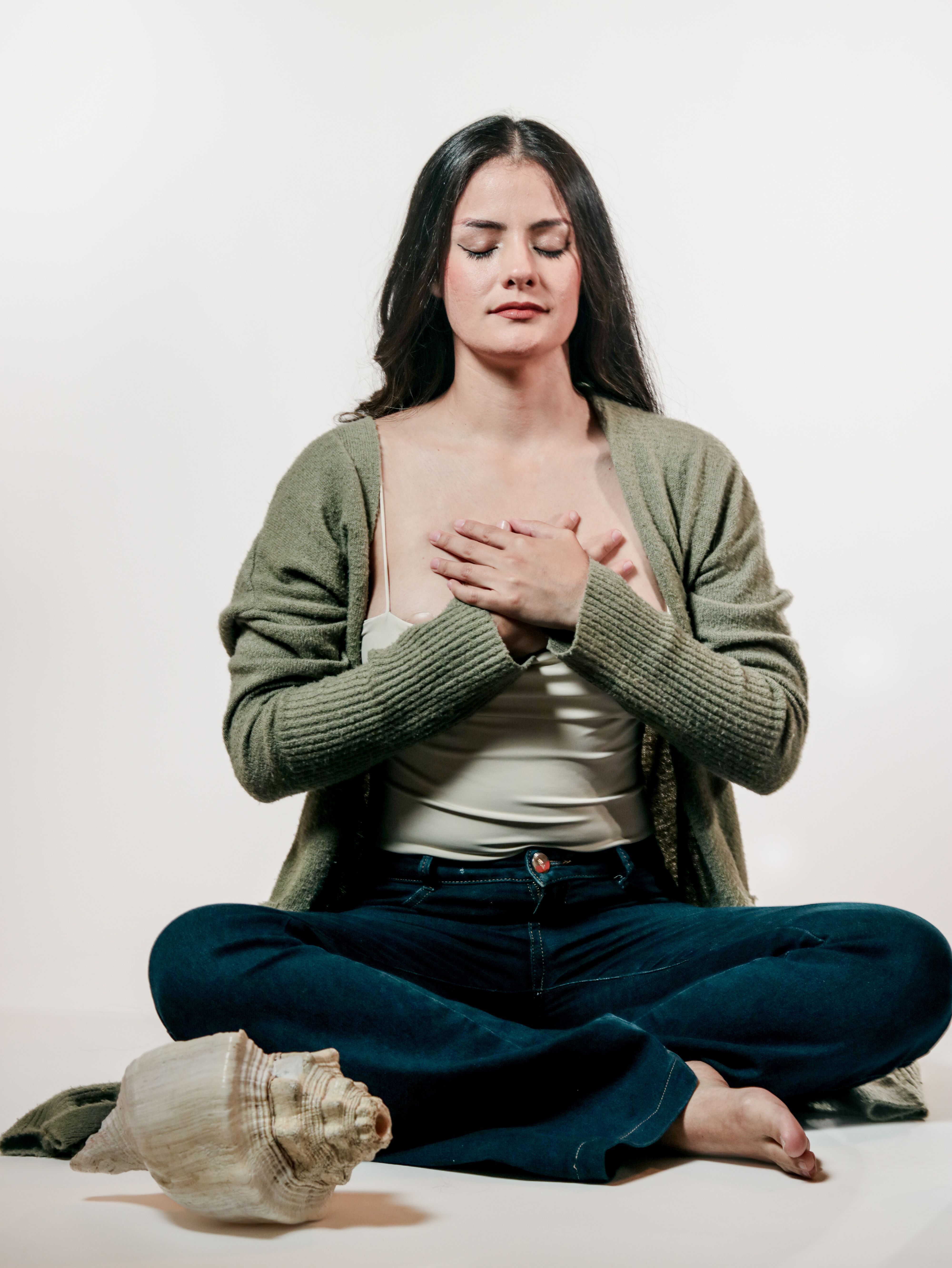 Meditative Woman in Relaxing Pose with Conch Shell · Free Stock Photo
