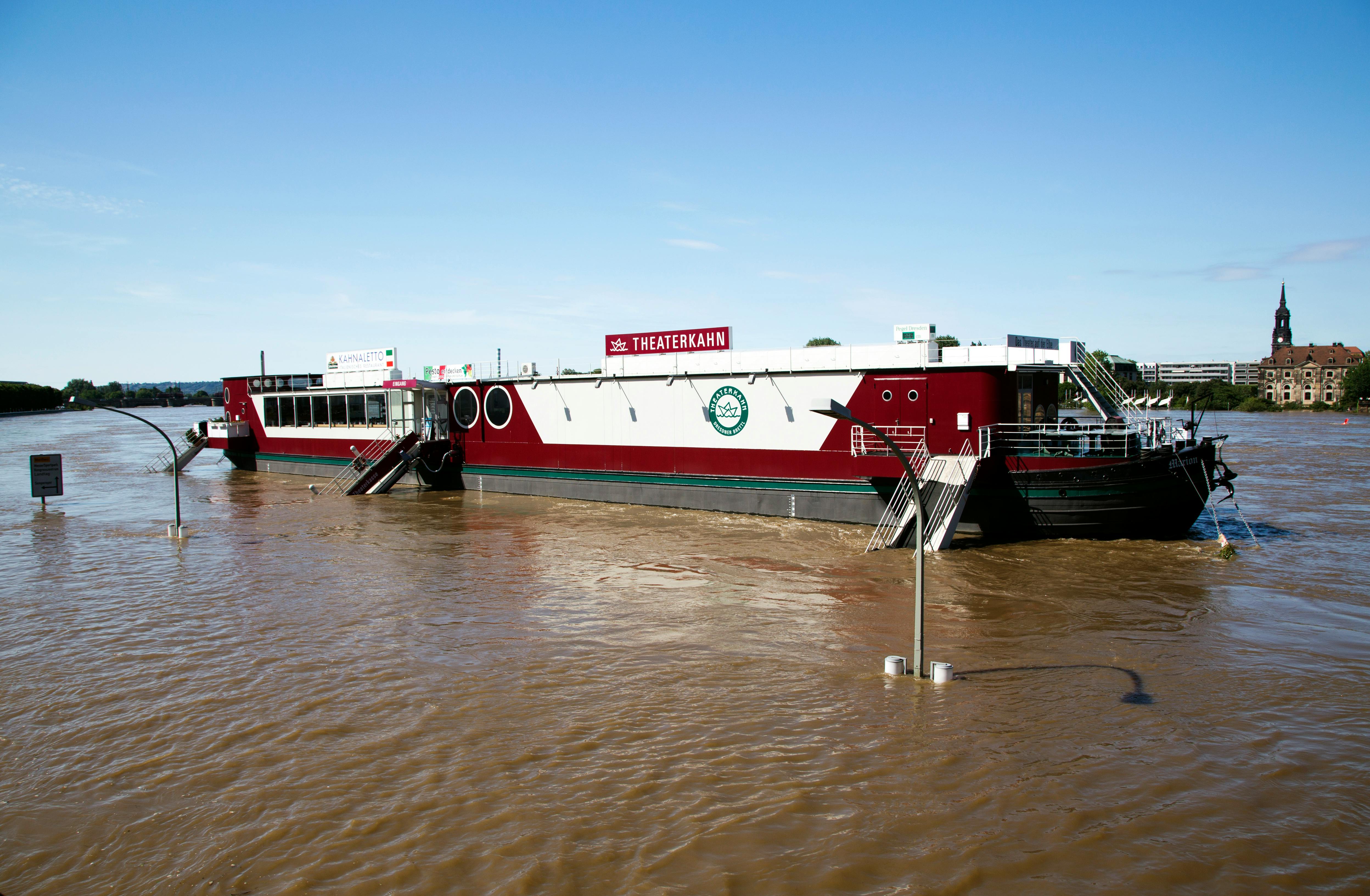 Free A theater barge named Theaterschiff on brown flooded river under clear sky. Stock Photo