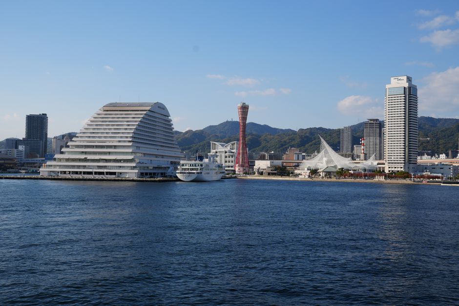 View of Kobe Port skyline featuring iconic harbor tower and modern architecture.