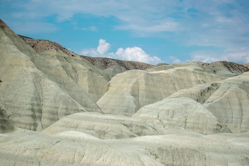 Free Captivating image of stark badlands with a clear blue sky, showcasing unique geological formations. Stock Photo