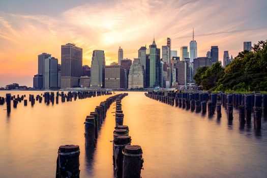 Scenic view of Manhattan skyline at sunset, seen from Brooklyn Bridge Park, New York City.