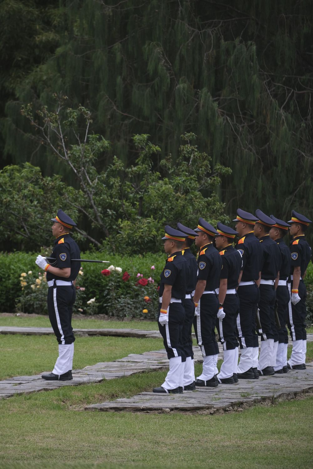 Uniformed cadets standing in formation outdoors