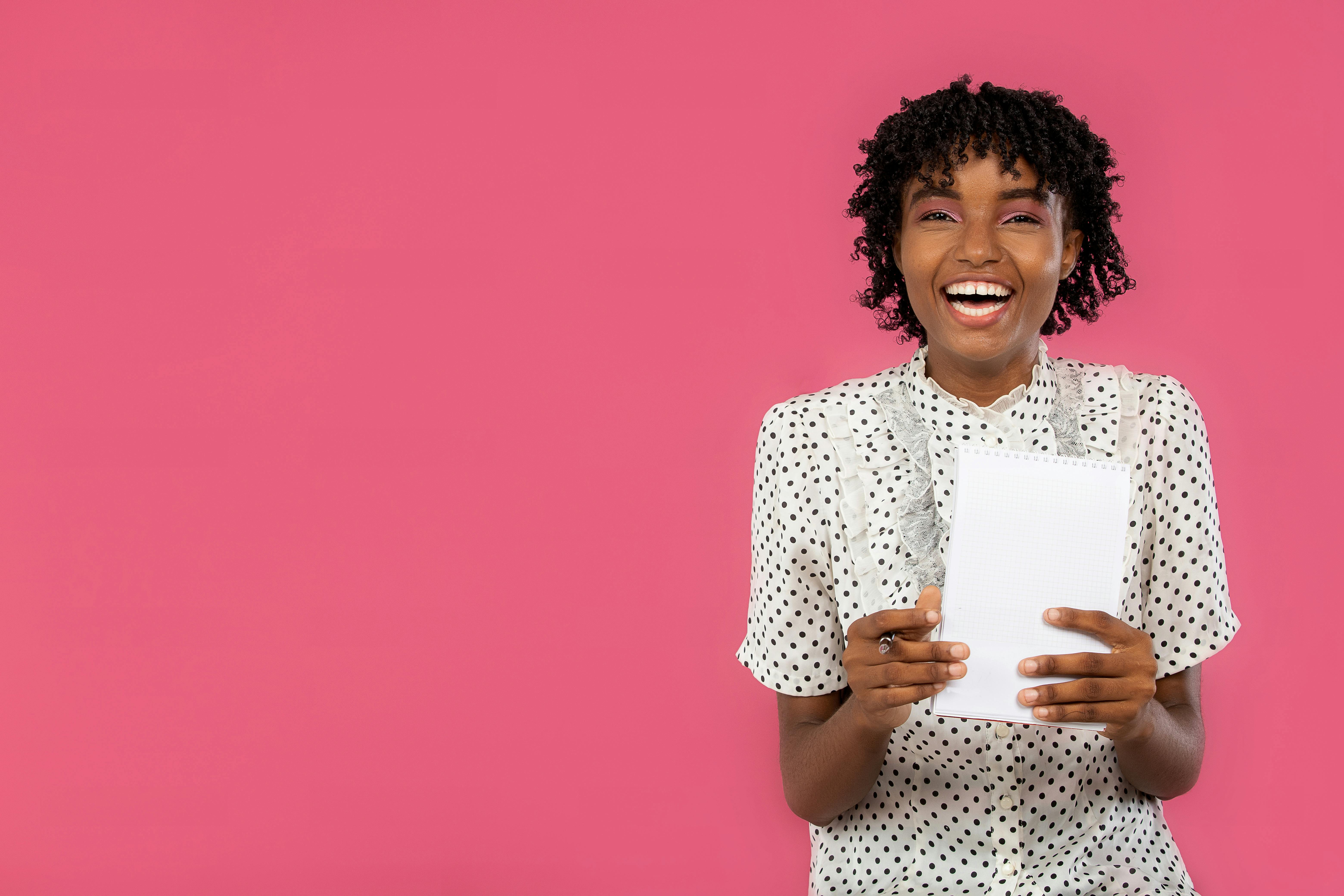 An author sitting with a notebook and a surprised expression on their face