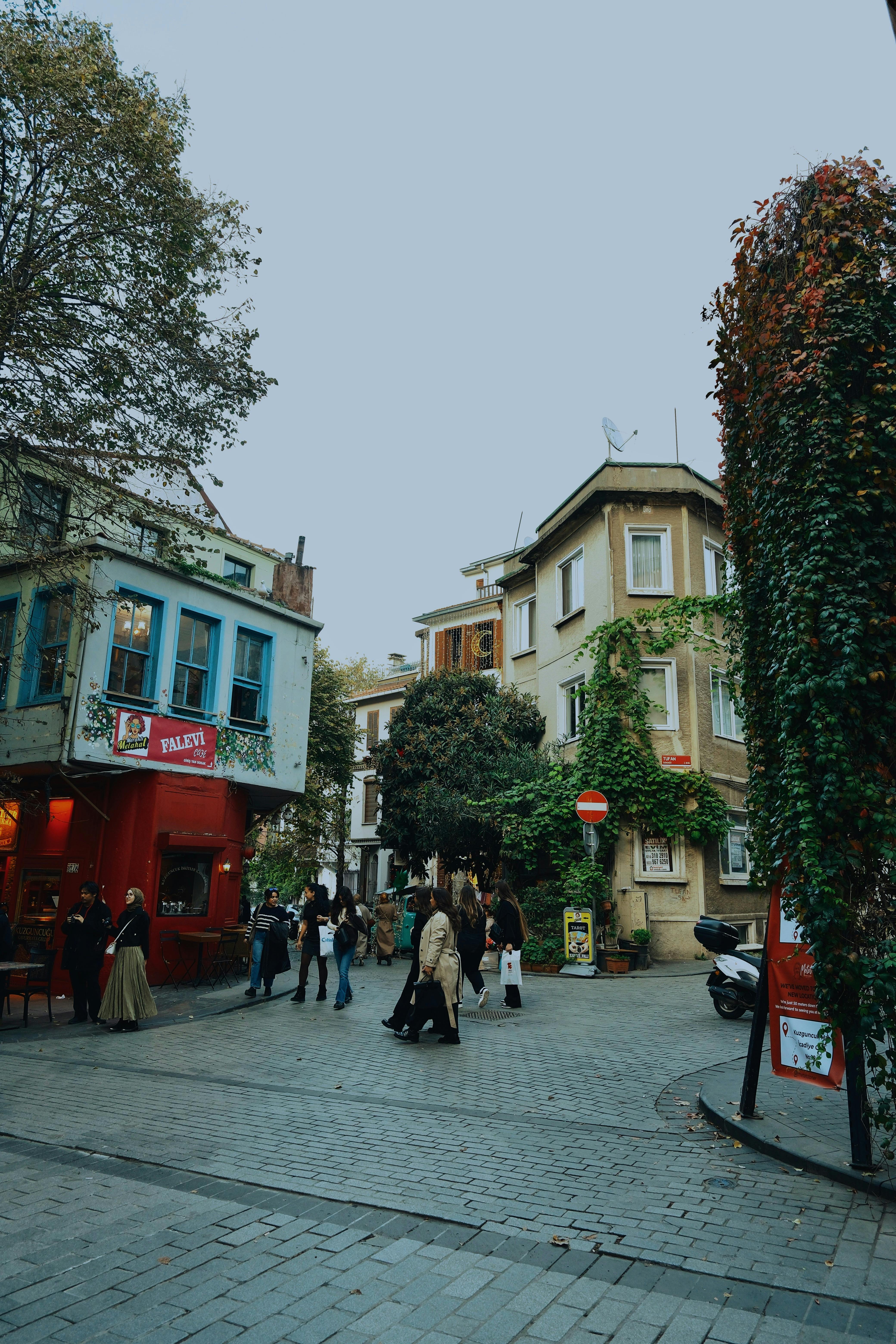Vibrant street corner with historic architecture and pedestrians in an urban setting.