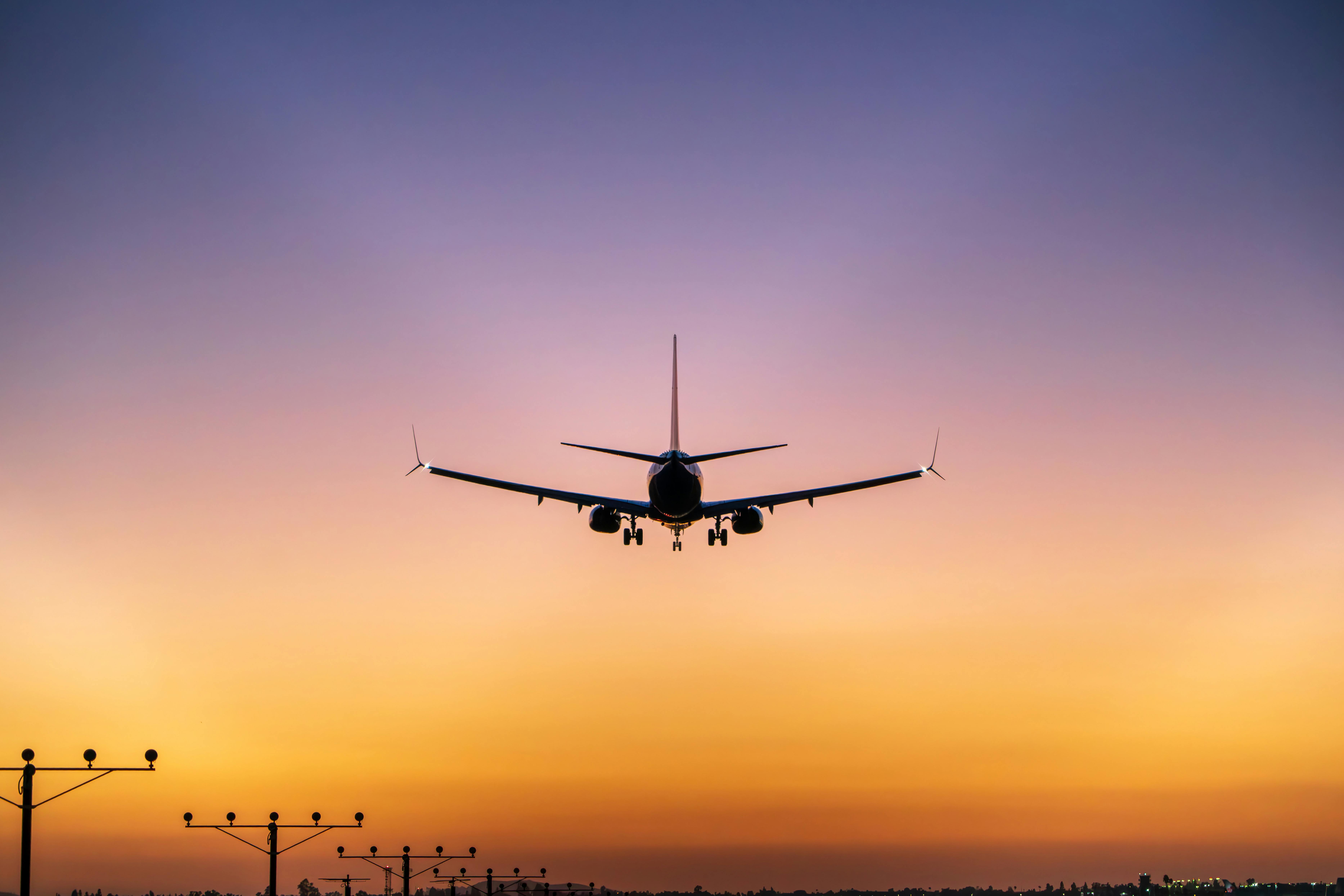 Free Silhouette of an airplane landing with a stunning sunset sky in Ontario, California. Stock Photo