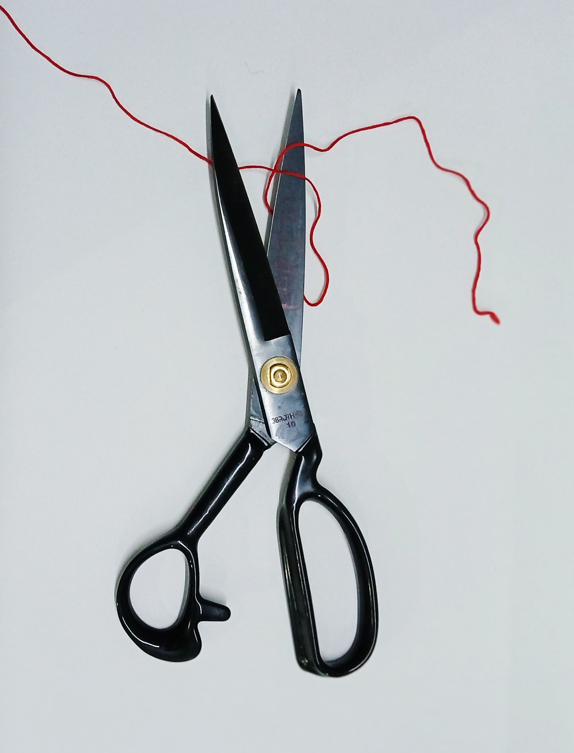 scissors cutting thread string
