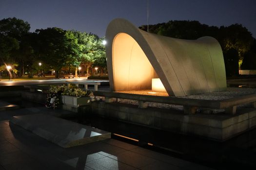 Illuminated Hiroshima Peace Memorial Park captured at night, serene and hauntingly beautiful.
