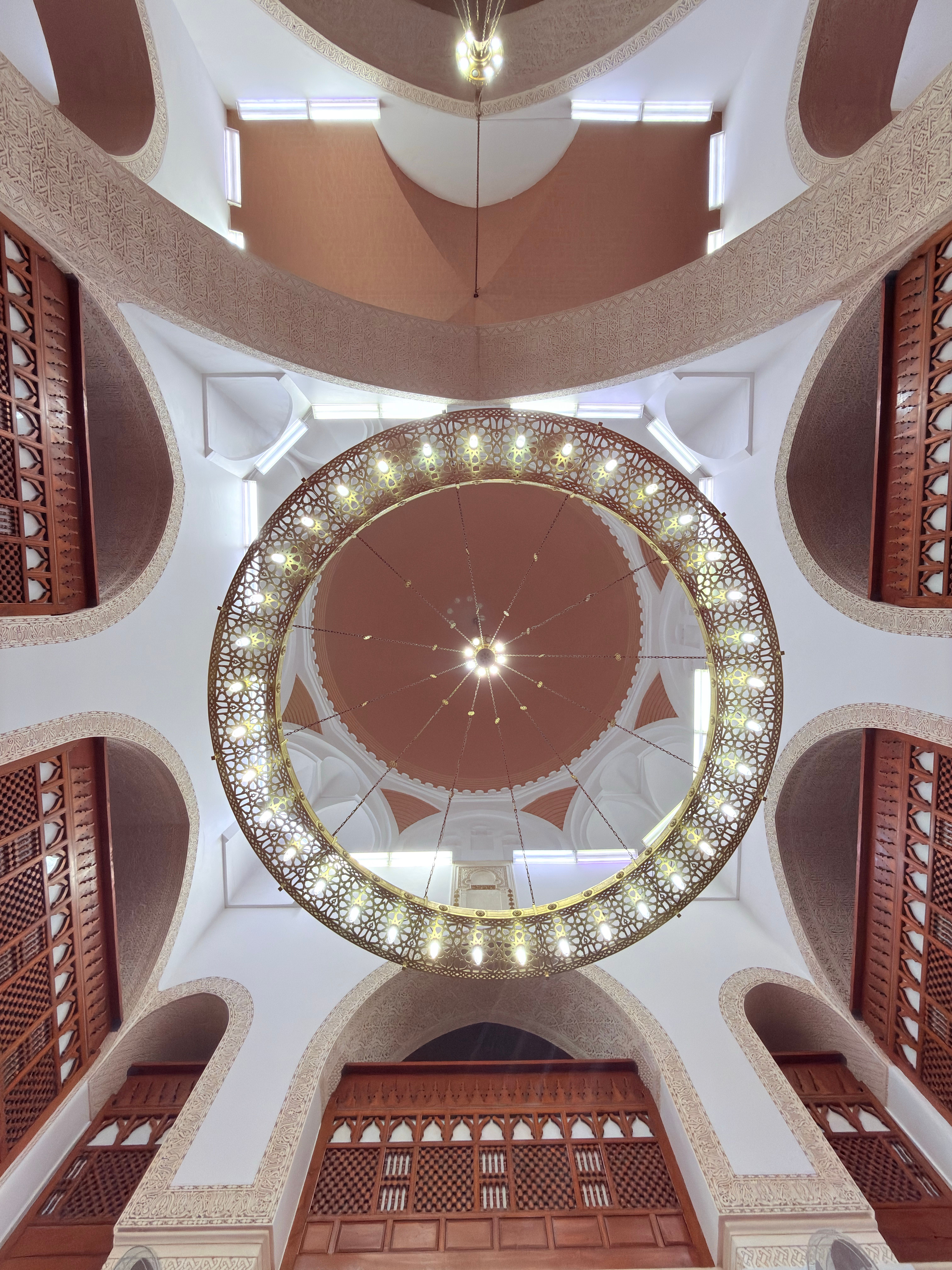 Beautiful interior view with decorative dome and arches of a mosque in Madinah, Saudi Arabia.
