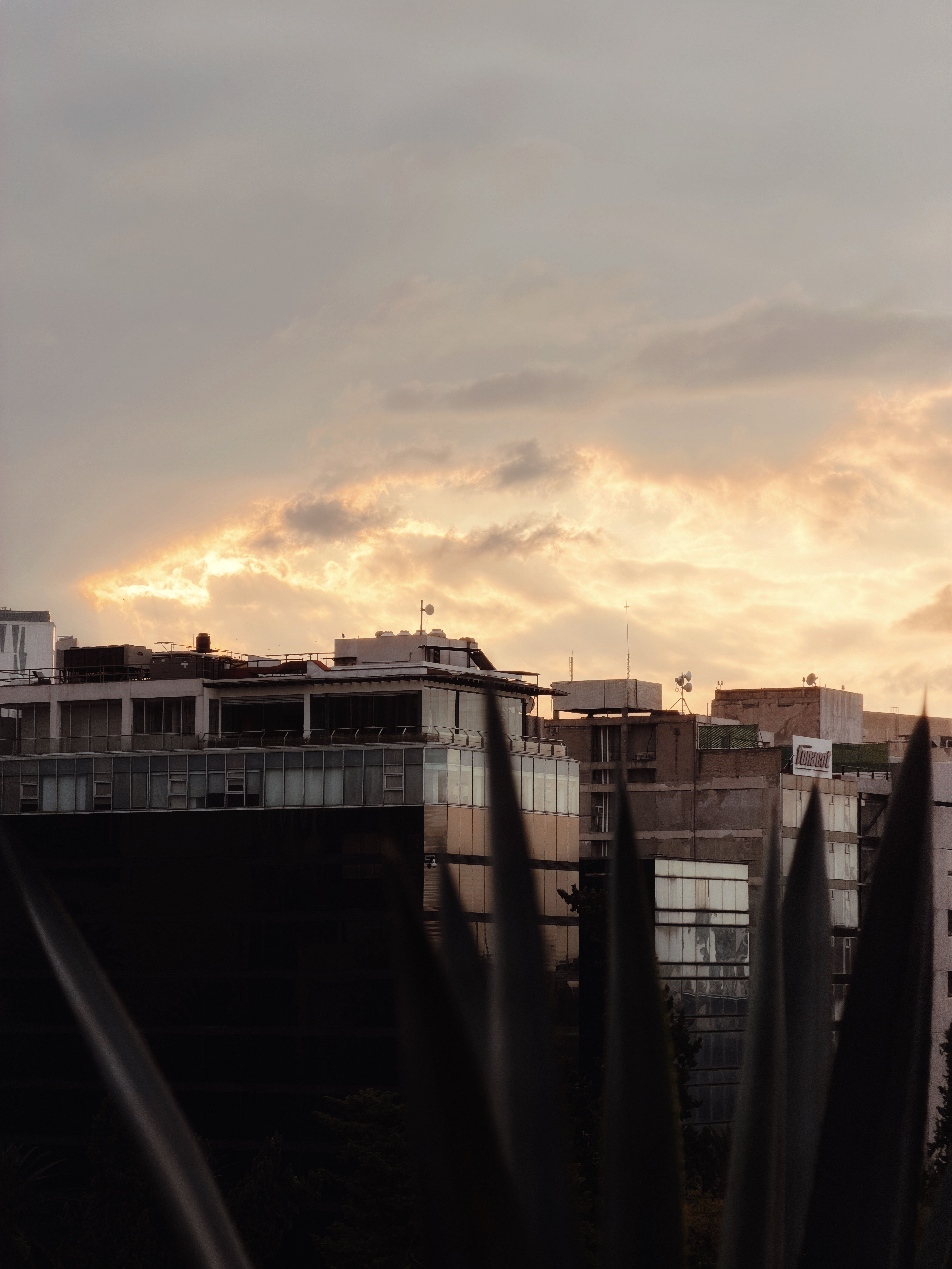 Sunset Over City Skyline with Dramatic Clouds · Free Stock Photo