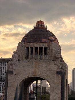 Iconic Monumento a la Revolución under a dramatic sky in Mexico City.