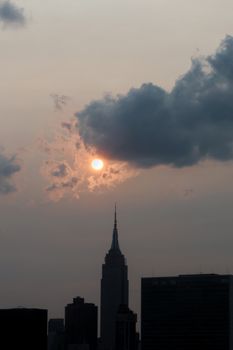 The Empire State Building silhouetted against a dramatic twilight sky in New York City.