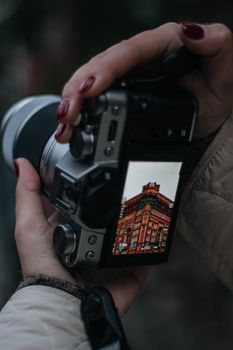 Photographer capturing a historic building in Istanbul with a DSLR camera.