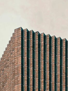 Close-up of a modern building with a unique geometric facade and repeating patterns.
