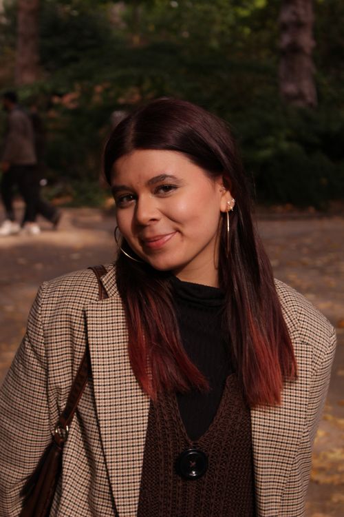 Free Young woman with red hair highlights smiling outdoors in a park during autumn. Stock Photo