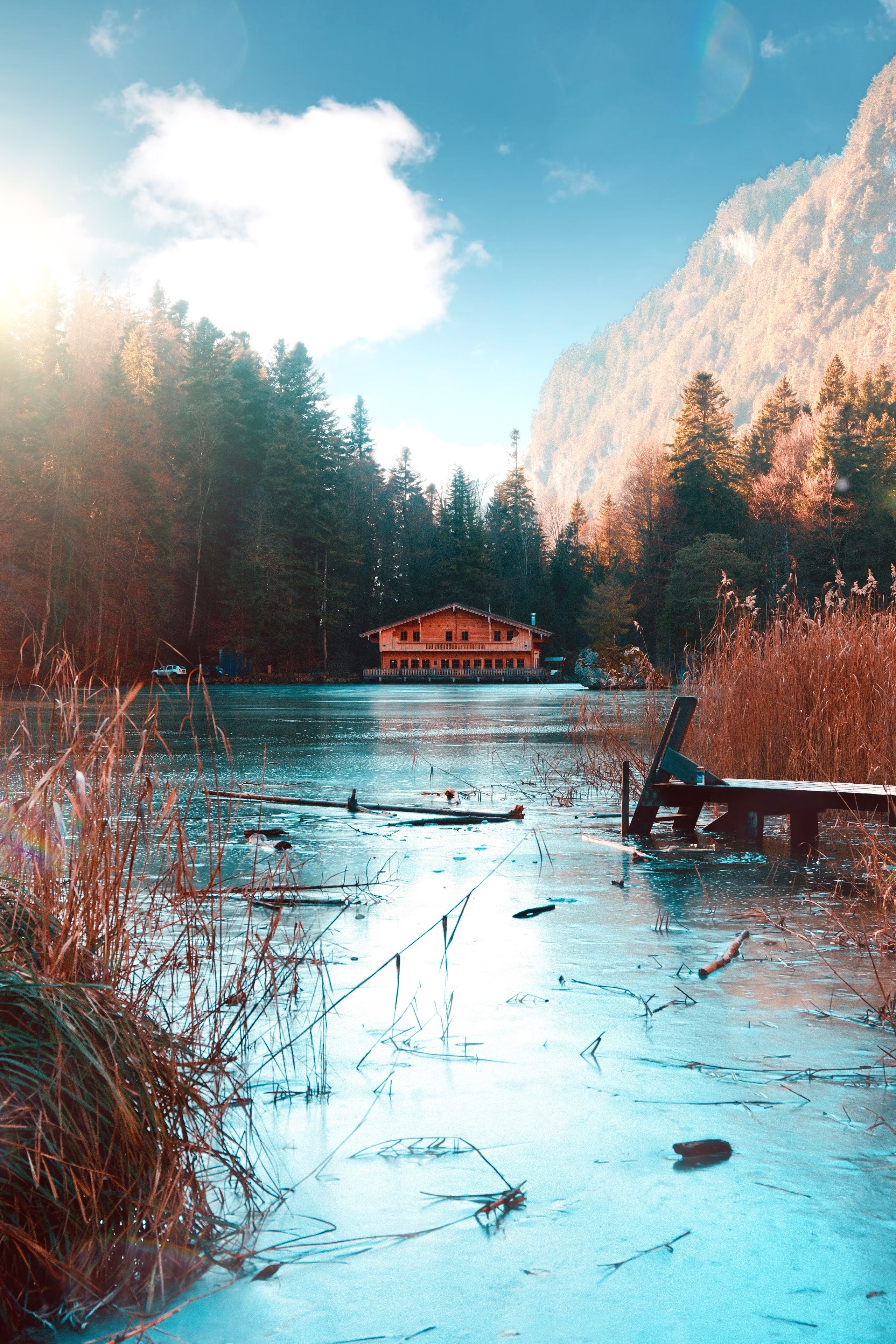 Serene Winter Cabin by a Frozen Lake · Free Stock Photo