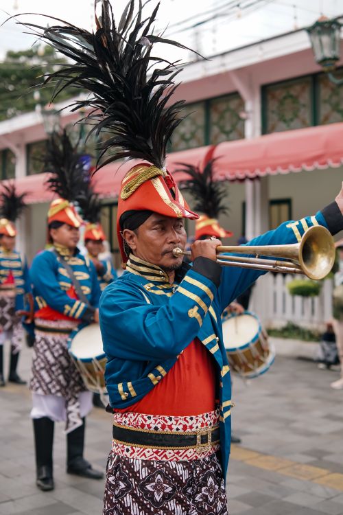 Free Colorful cultural parade in Yogyakarta featuring traditional costumes and musical performance. Stock Photo