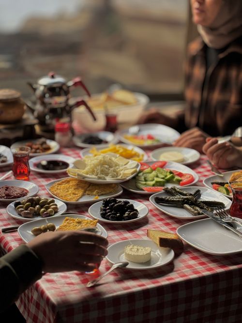Free Delicious array of breakfast dishes on checkered table with teapot, ideal for food and lifestyle themes. Stock Photo