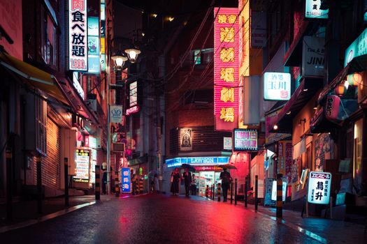 Experience the neon-lit streets of Tokyo at night. A vibrant scene full of bustling urban life.
