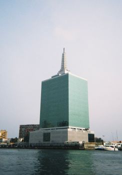Iconic Lagos skyscraper by the waterfront in daylight, showcasing modern architecture.