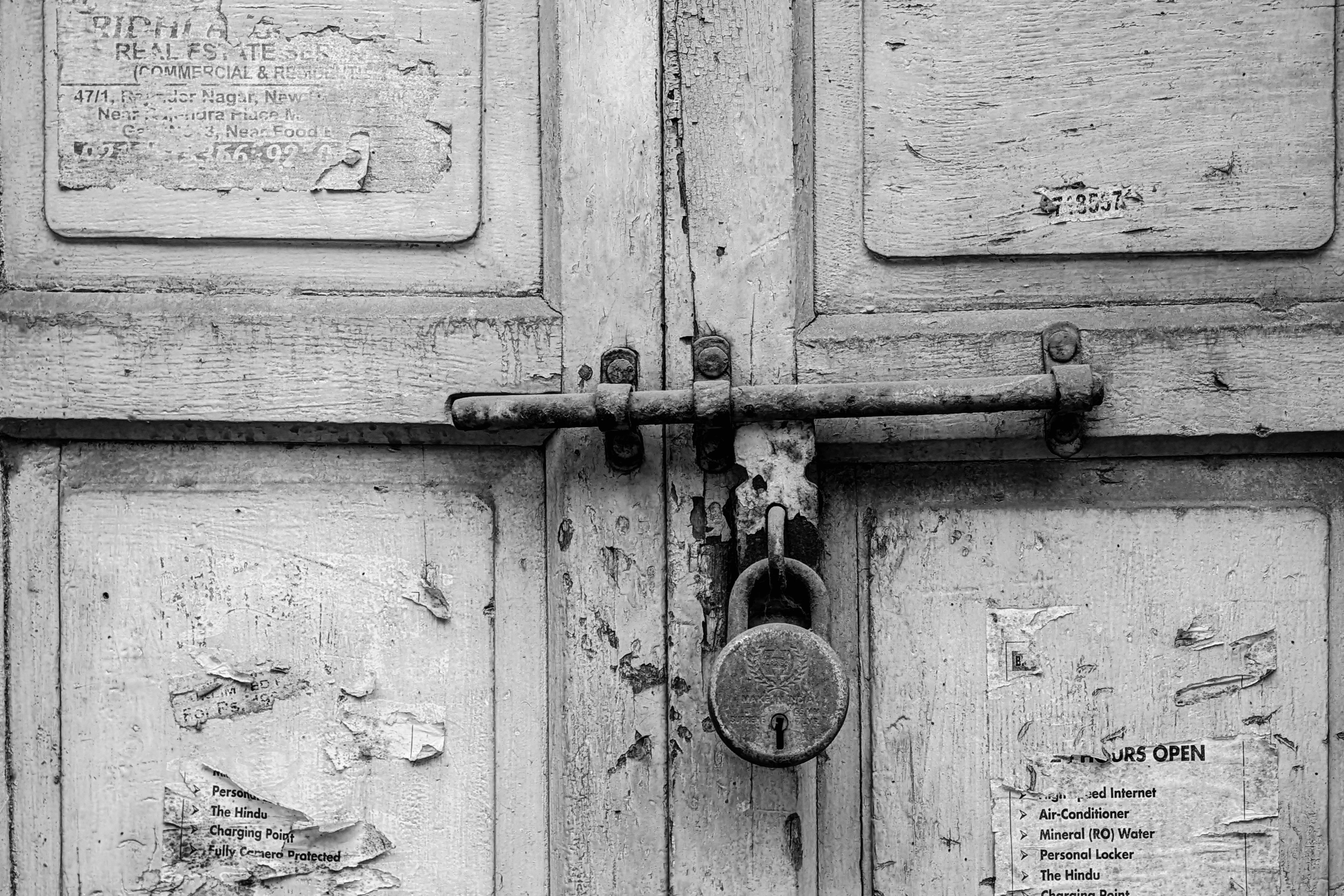 worn scratched old deadbolt with loose strike plate on the same white apartment door