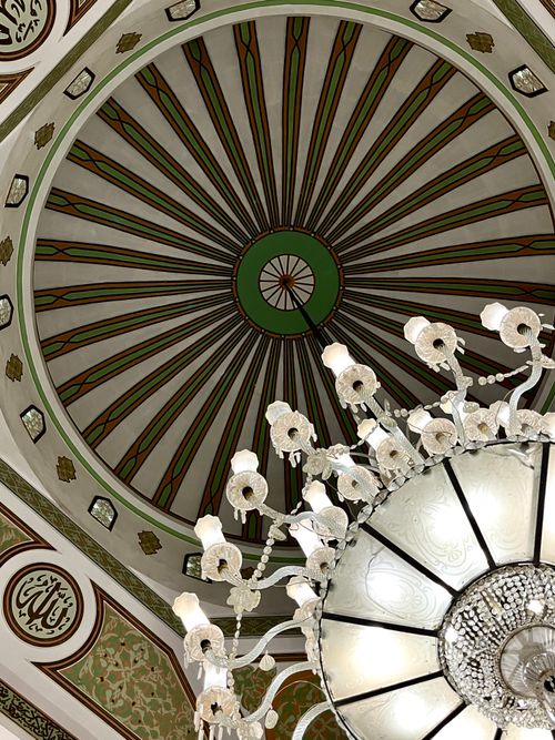 Free A detailed view of a mosque's dome and chandelier showcasing Islamic architectural elegance. Stock Photo