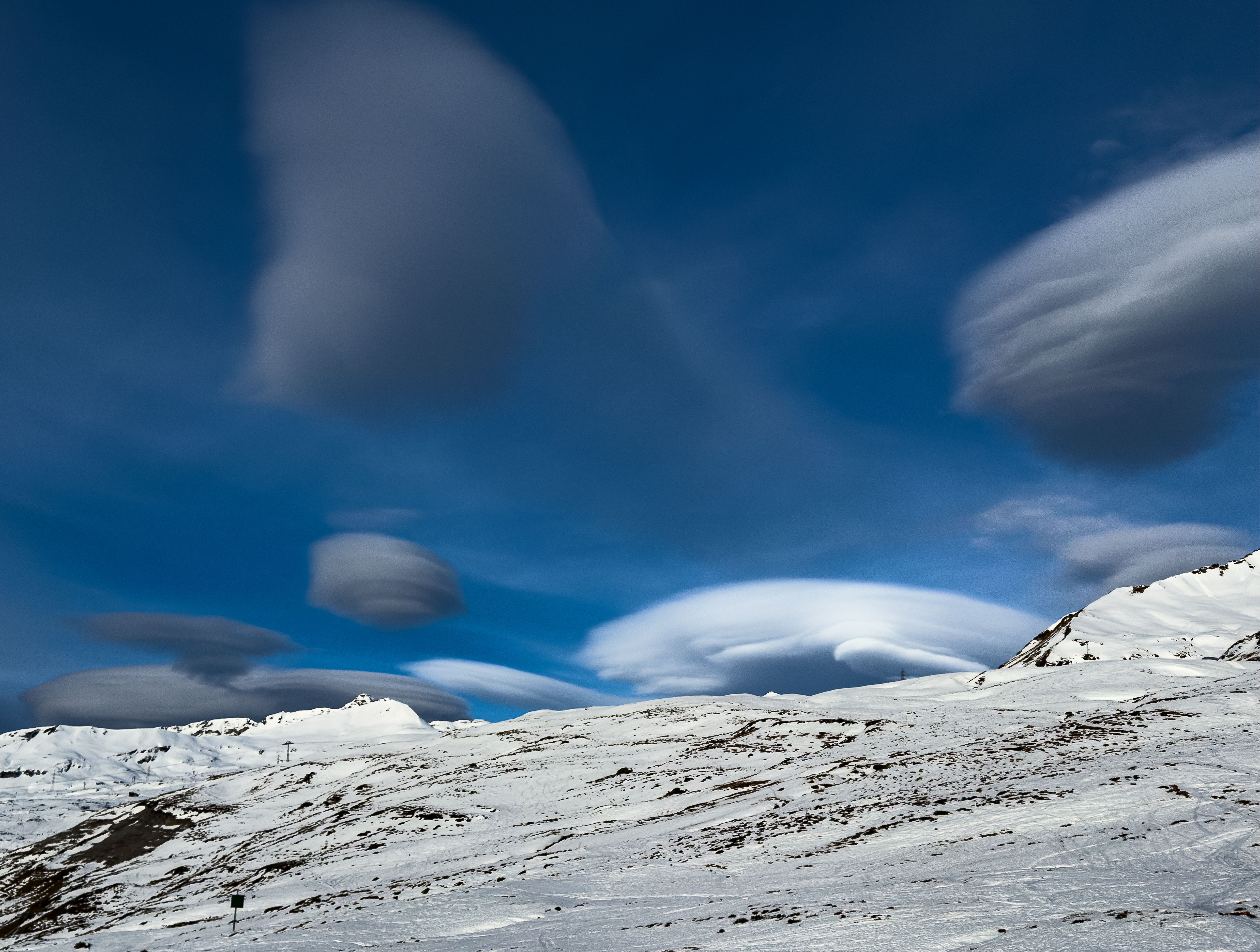 Ethereal Lenticular Clouds Over Snowy Mountain Landscape · Free Stock Photo