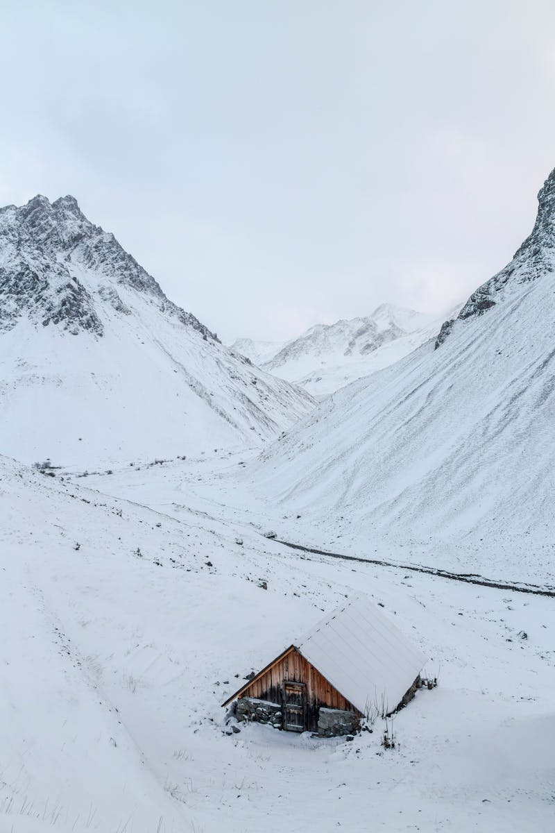 A serene snow-covered cabin in the mountainous region of Auvergne-Rhône-Alpes, France.
