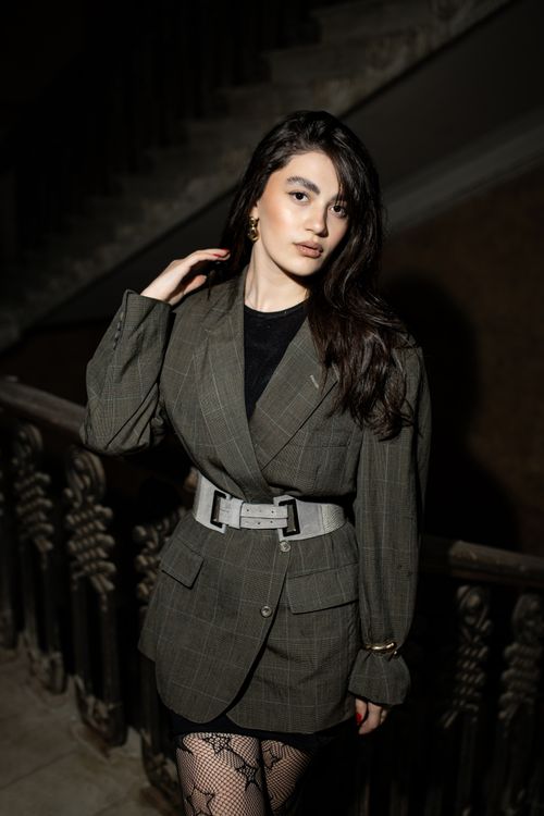 Free Elegant portrait of a woman in a stylish suit with natural lighting, capturing a moody and timeless essence. Stock Photo