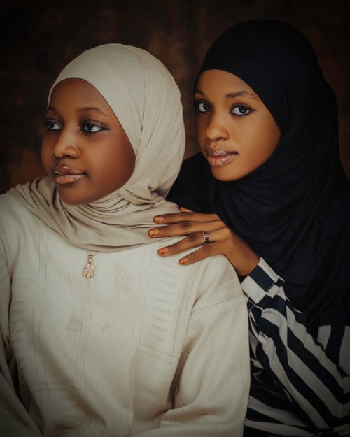 Free Elegant portrait of two women in hijabs showing friendship and unity. Stock Photo