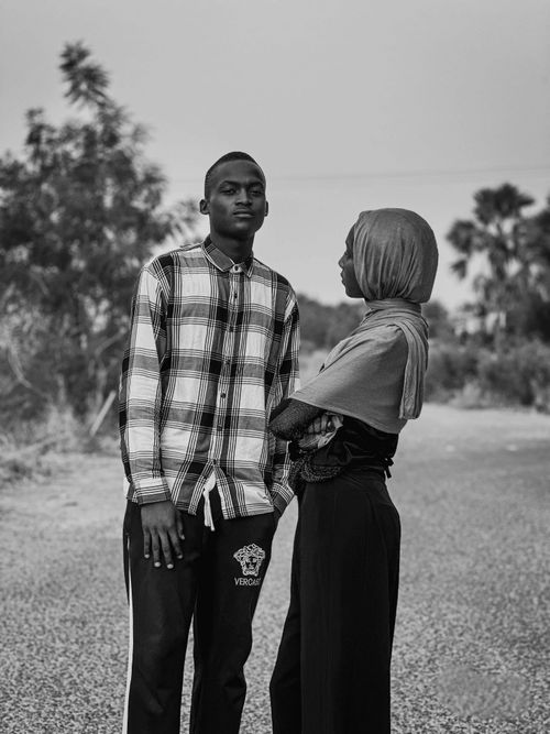 Free A stylish young couple poses outdoors in an artistic black and white photograph. Stock Photo