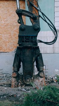 A close-up view of a heavy duty demolition machine part used in construction and building site operations.