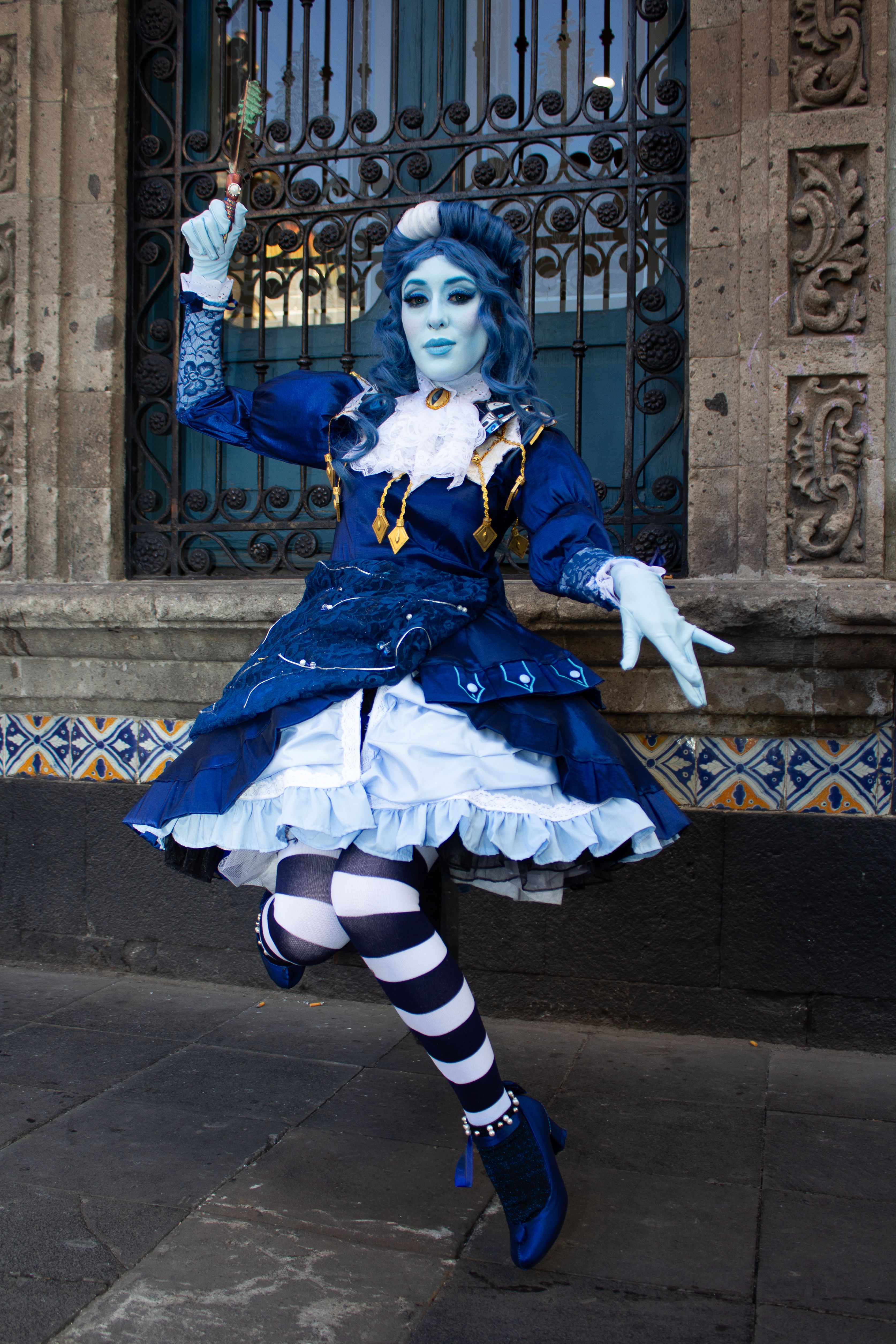 Cosplay Performer in Blue Costume by Ornate Building