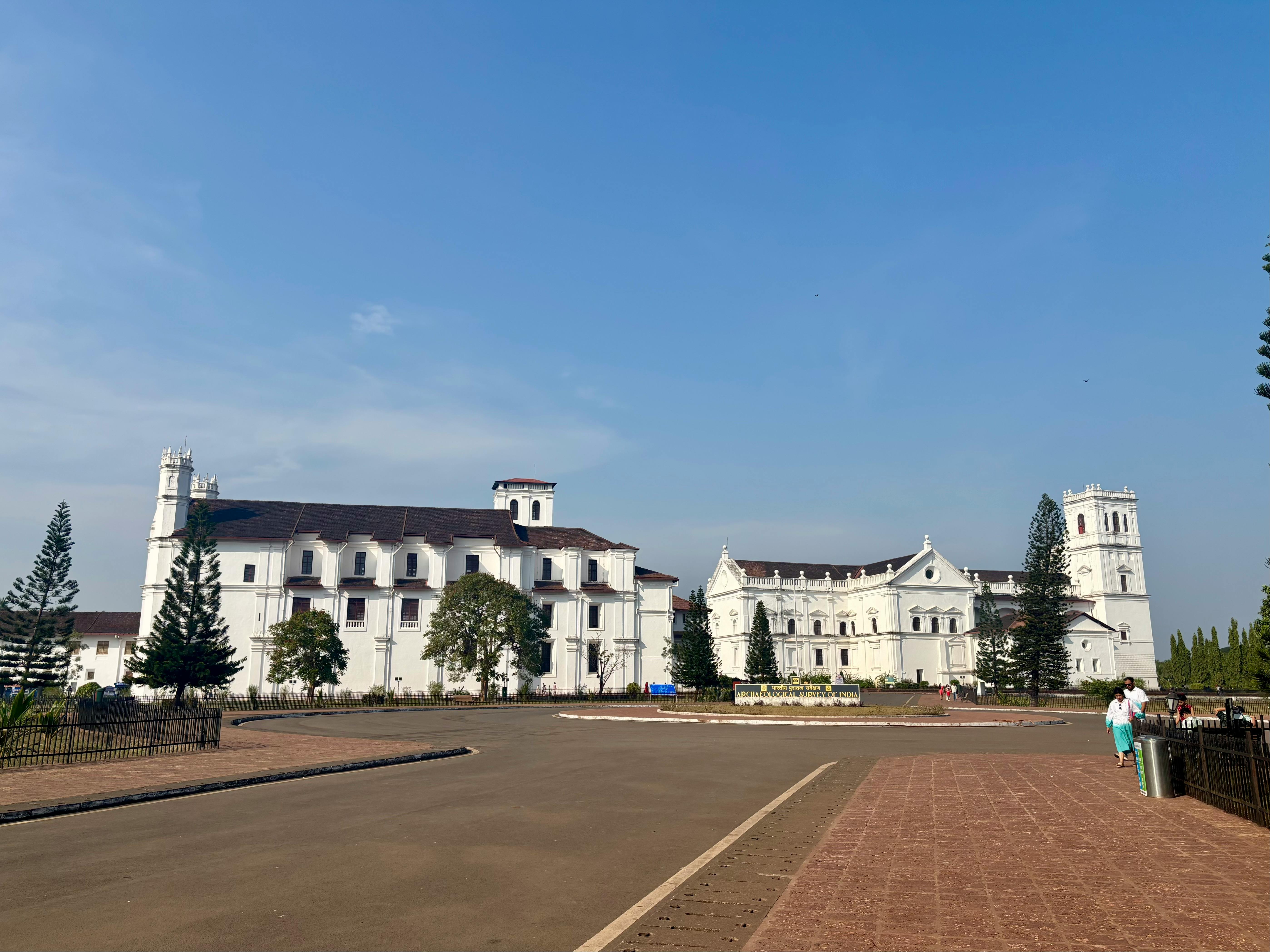 Beautiful view of Se Cathedral, a historic landmark in Old Goa, under a bright blue sky.
