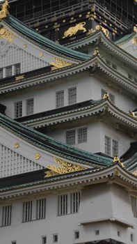 Intricate details of Osaka Castle's roof showcasing Japanese architecture's elegance.