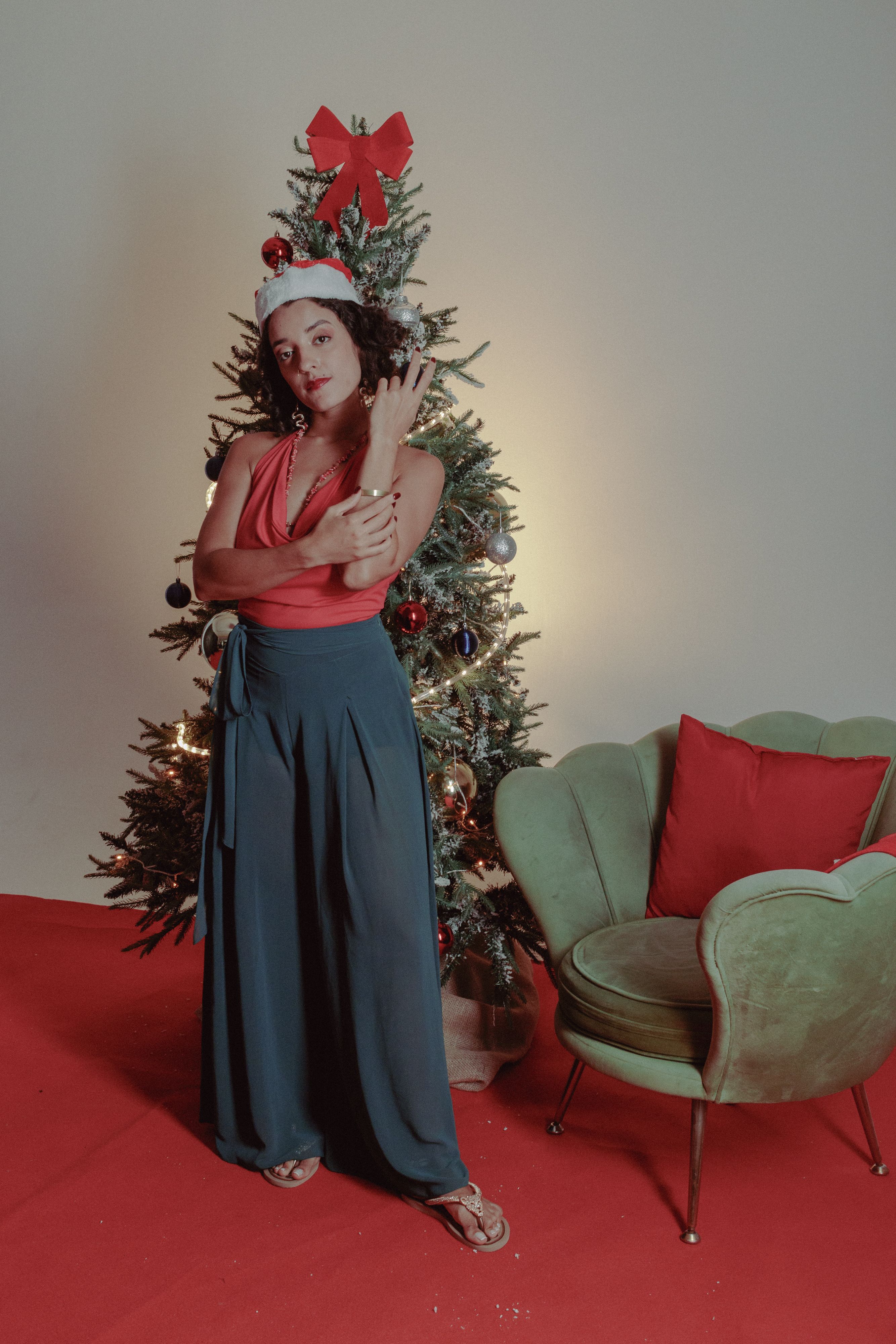 Festive Woman Posing by a Christmas Tree · Free Stock Photo