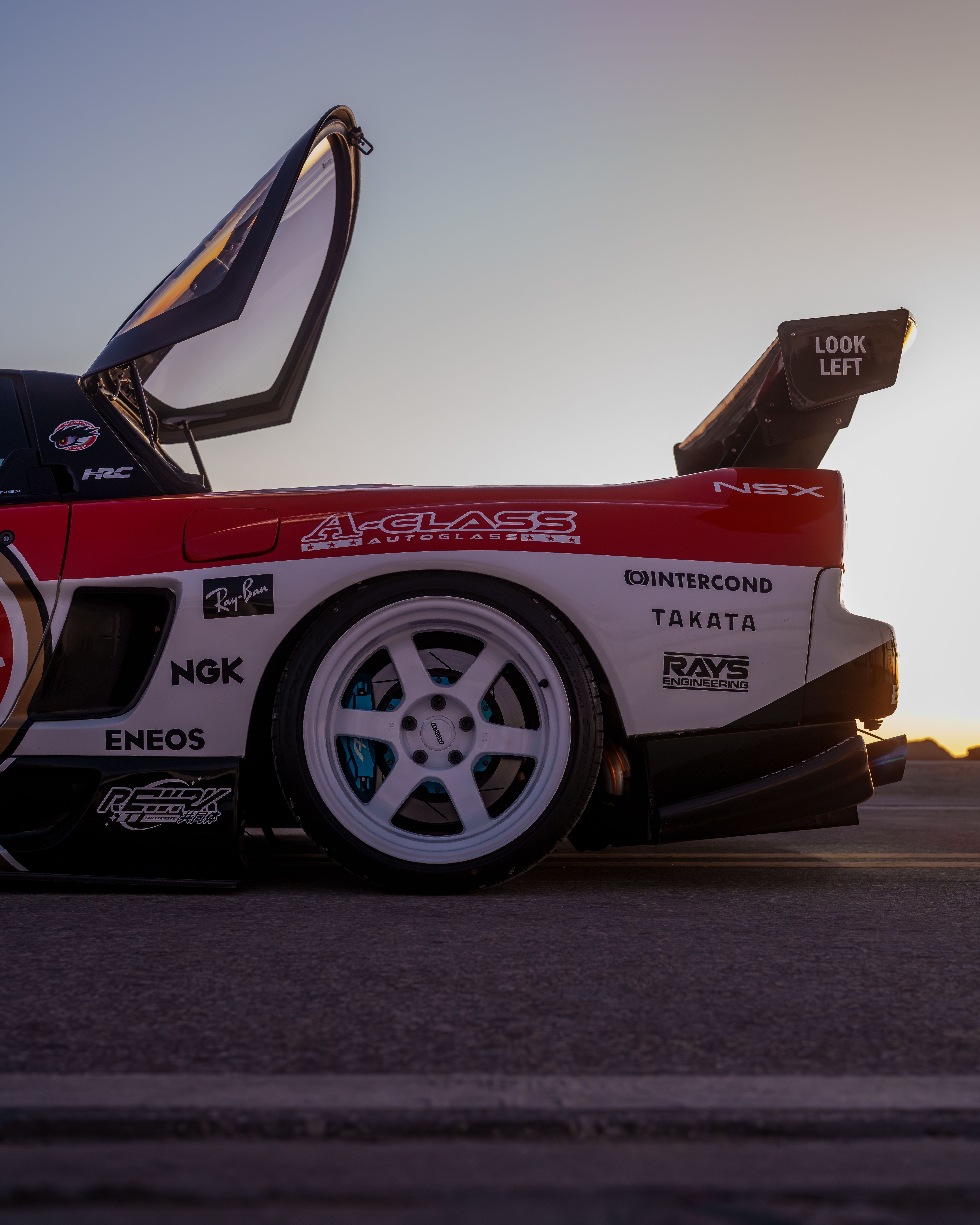 Sleek Sports Car with Gullwing Doors at Sunset · Free Stock Photo
